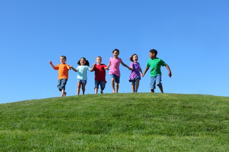 Kids running in field-Shutterstock