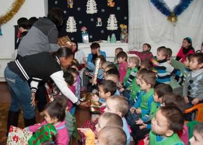 Service member volunteers from the Transit Center at Manas hand out presents to children at the Belovodski Preschool Orphanage in Karabalta, Kyrgyzstan, Dec. 27, 2012. The orphanage houses more than 70 children between the ages of 3 and 7. (U.S. Air Force photo/Tech. Sgt. Rachel Martinez)