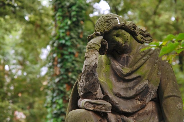 A sculpture of the mourning woman. Old graveyard.